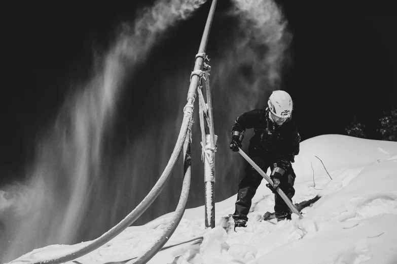 a man skiing down the side of a snow covered ski slope