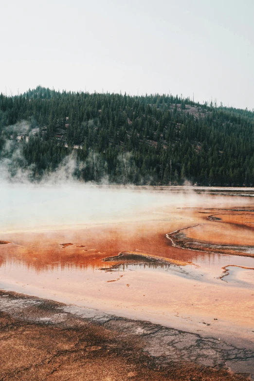 an arid area with steam rising from the ground