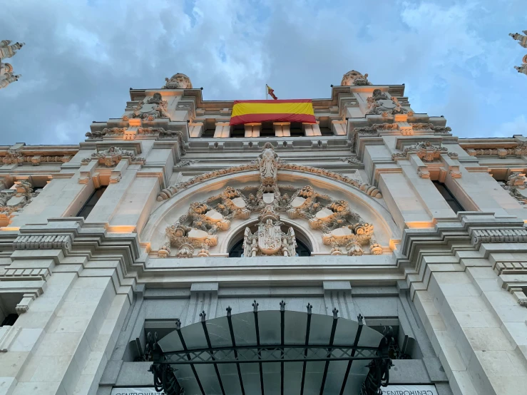 looking up at a large ornate stone building