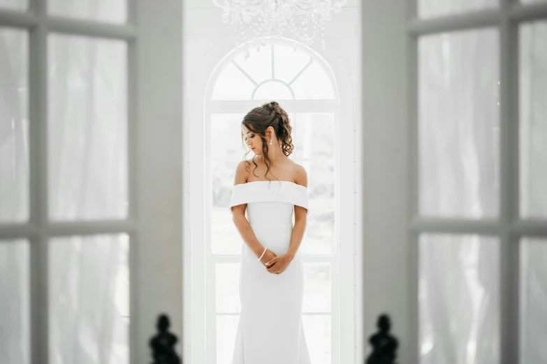 the back of a bride's dress and the brides hair is in a low id