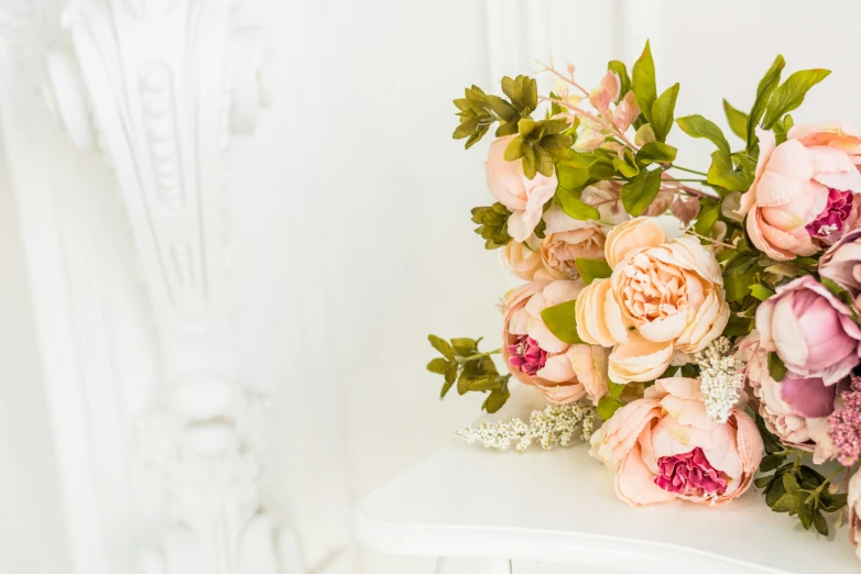 a bunch of flowers sit in a white room