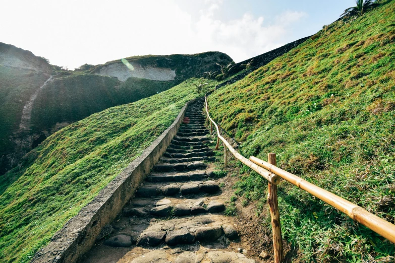 a person climbing stairs down a hill side