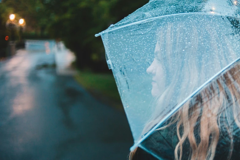 there is a woman with long hair holding a umbrella