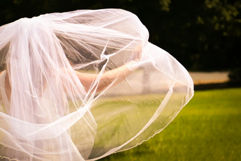 an image of a veiled woman in the grass