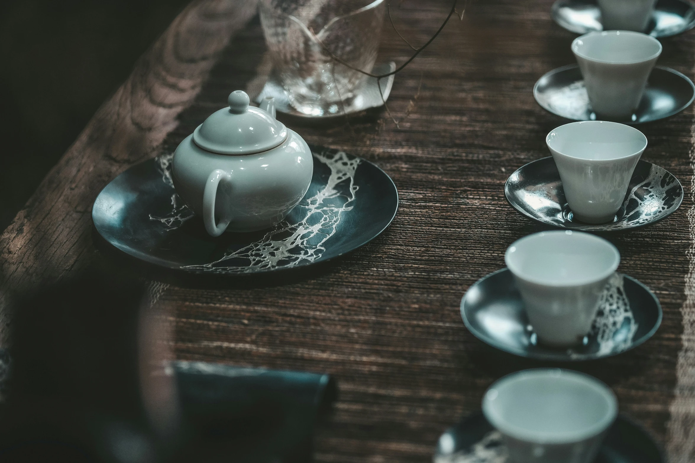 a table set for four with matching teacups