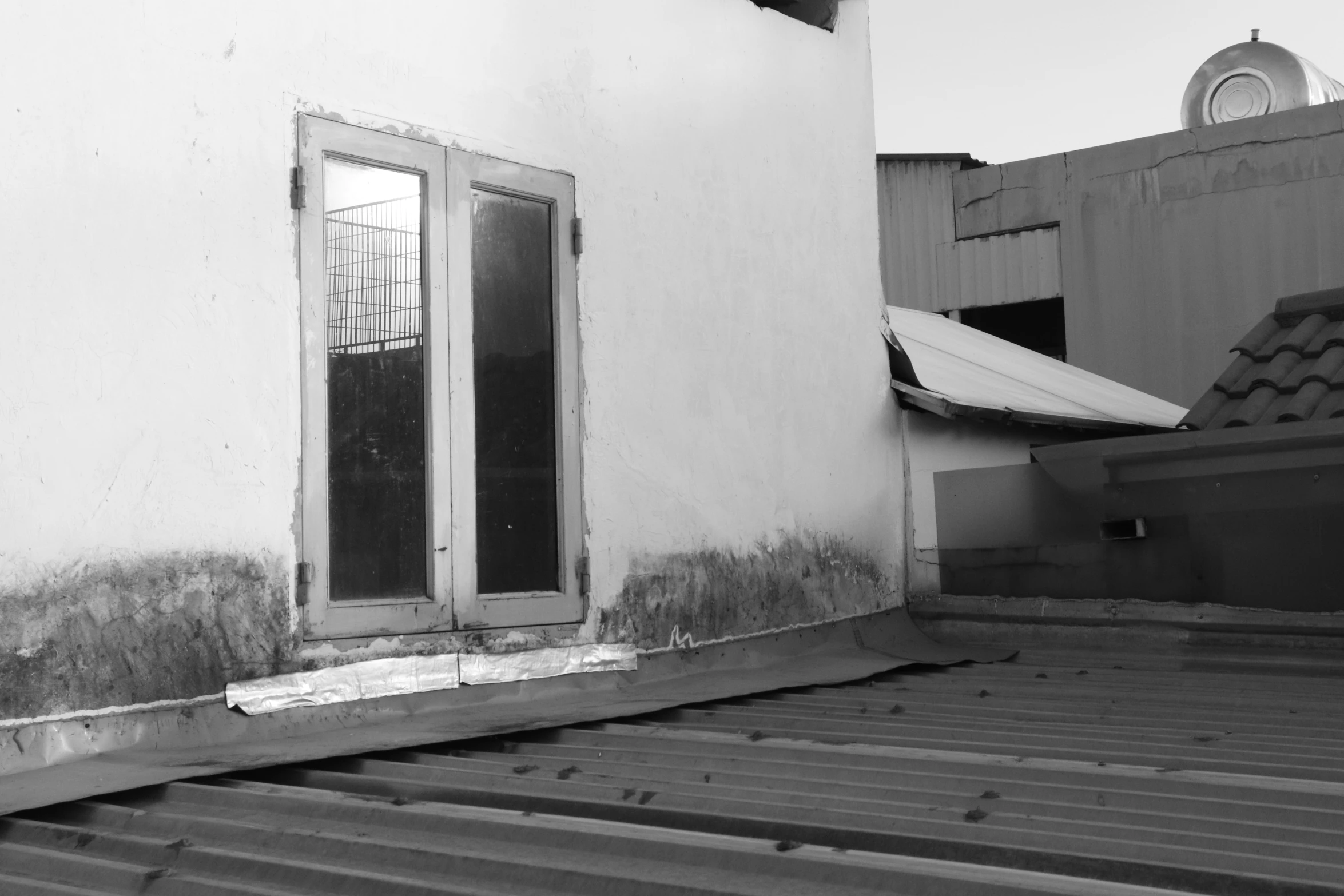 a view from outside of a house door, with a boat sitting on the other side