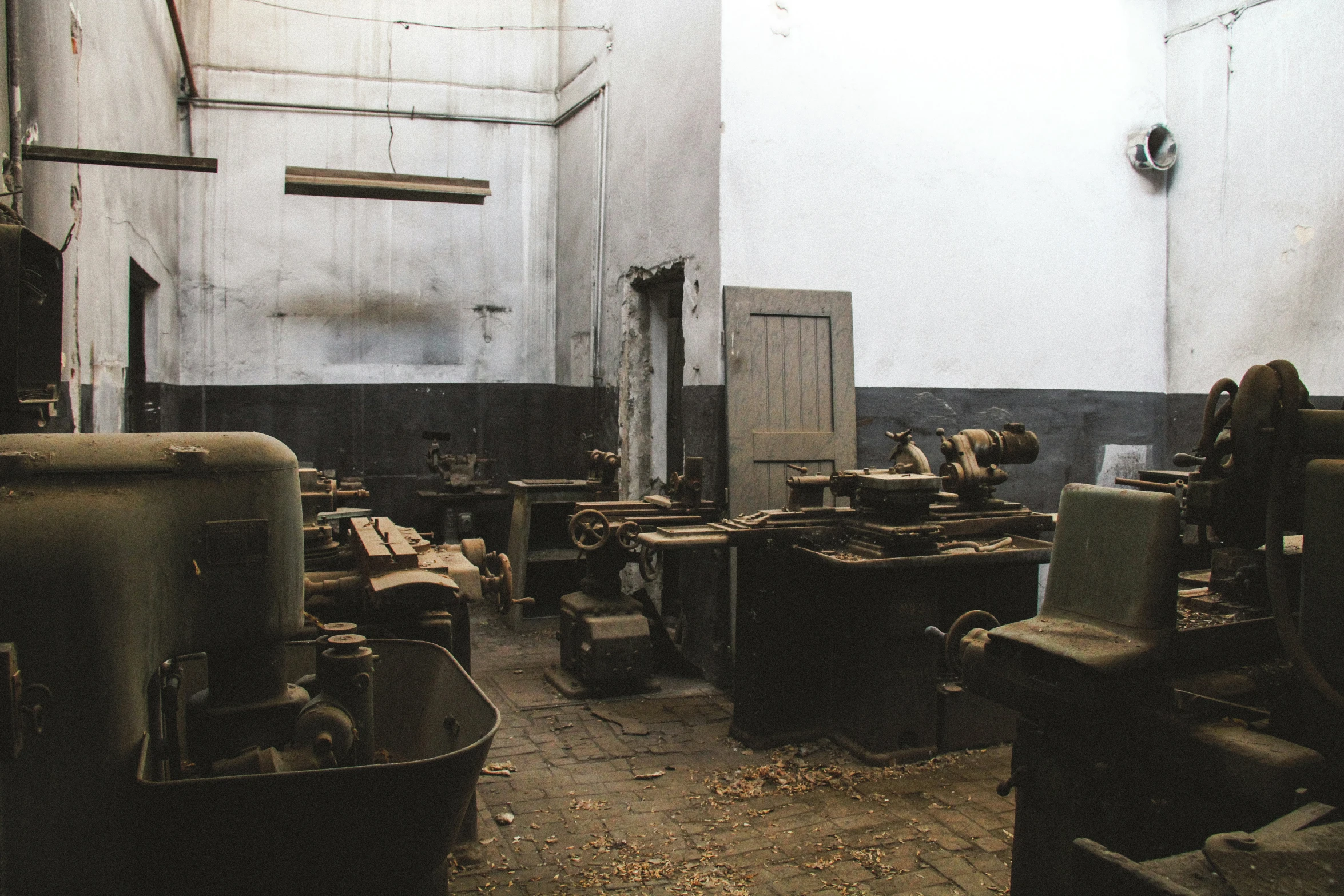 the inside of an old factory with machinery on the floor