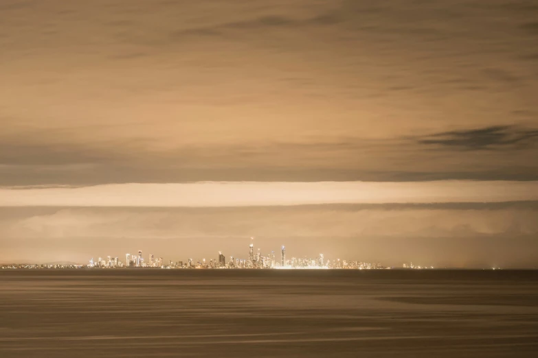 a boat in the water under a big cloud