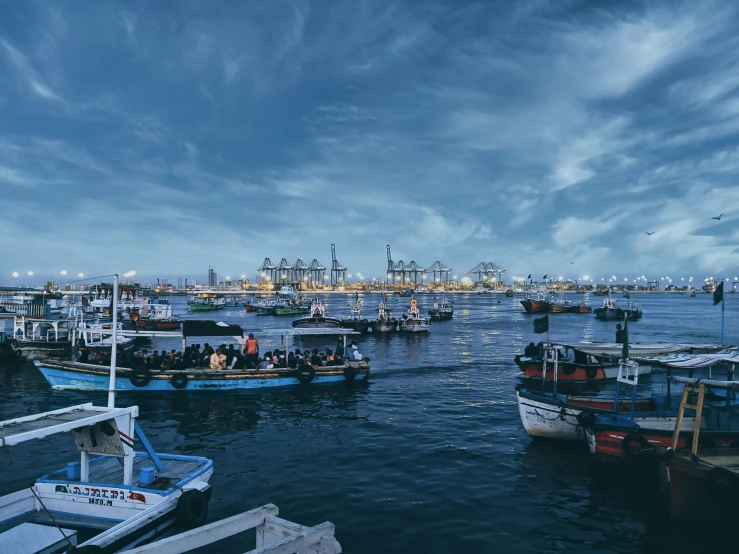 many small boats floating on the water near one another