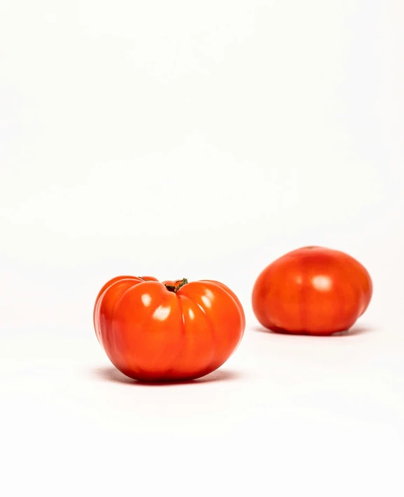 a couple of small tomatoes on a table