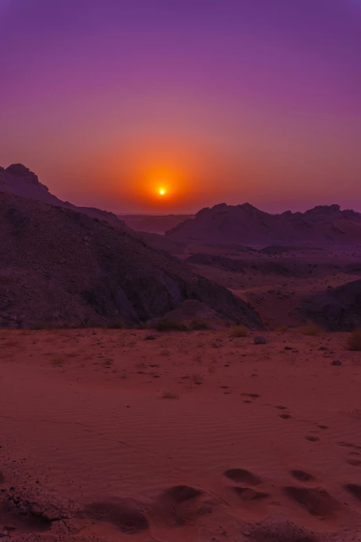 there is a po of some sand hills at sunset