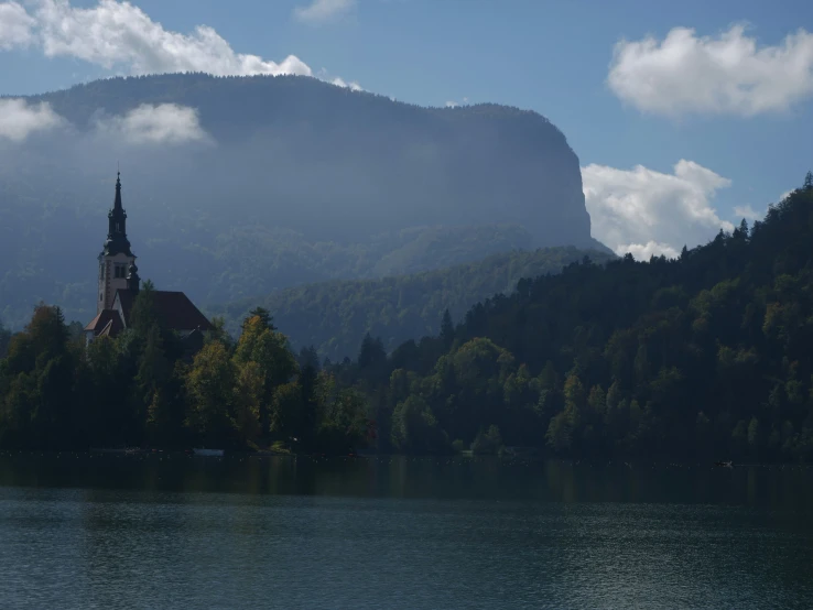 a large building with a steeple near water