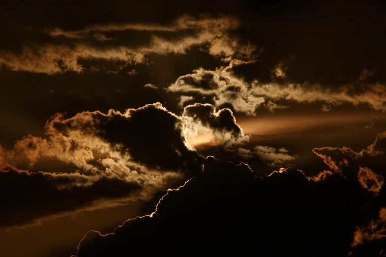 dark clouds are shown during the sunset, including lightening