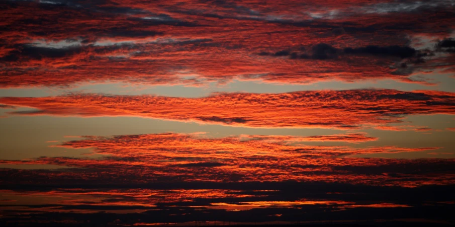 a sky that is very red with some clouds