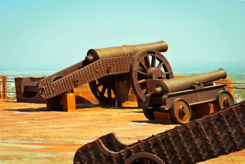 two metal objects on a wooden table next to each other