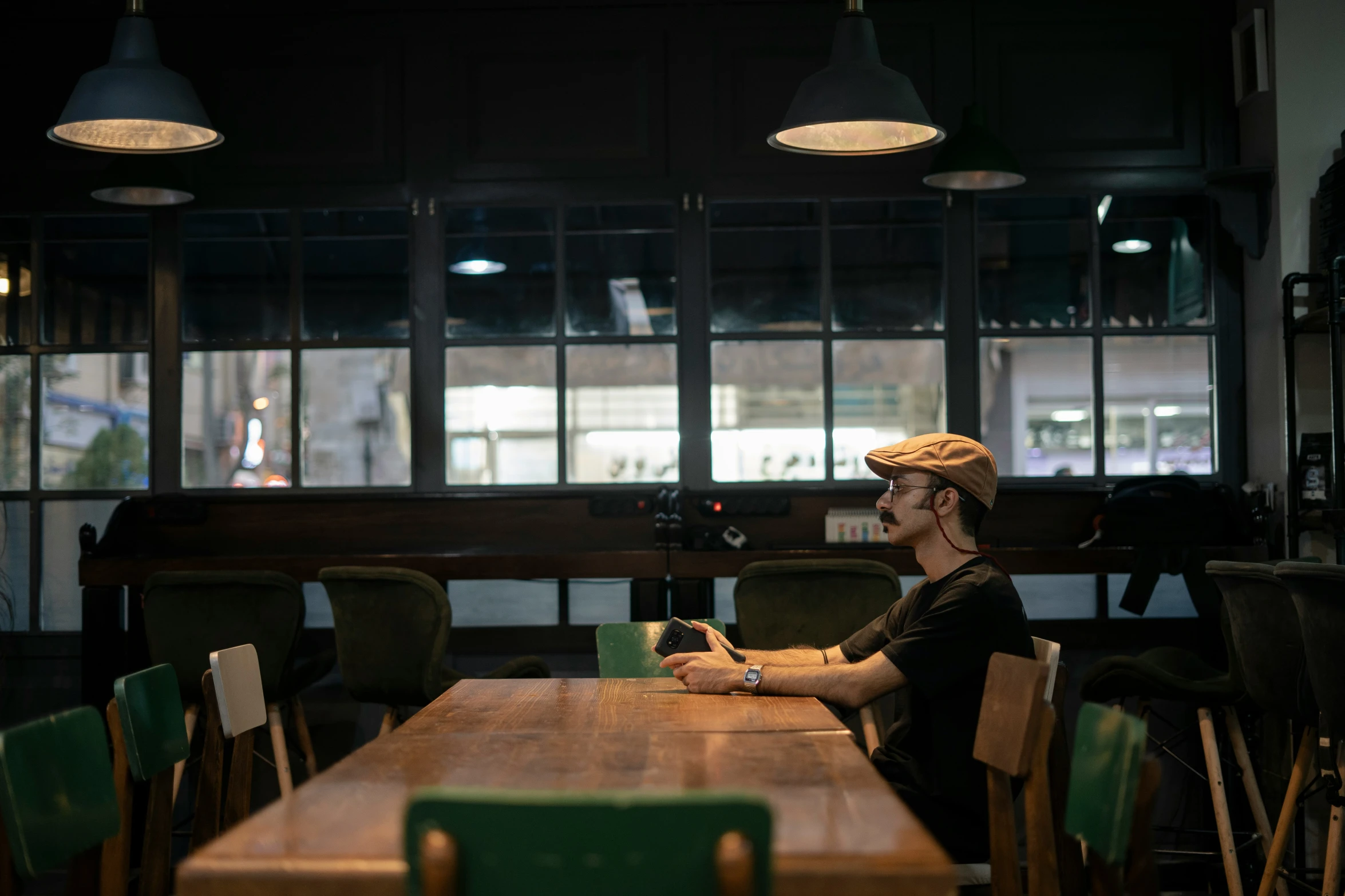 a lady sitting at a table using her cell phone