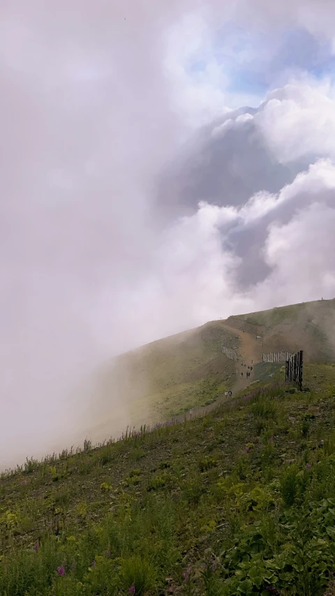 the smoke is rising from the hill to the grass