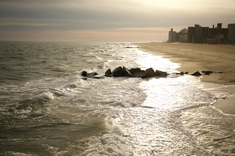 a beach covered in waves and waves coming to shore