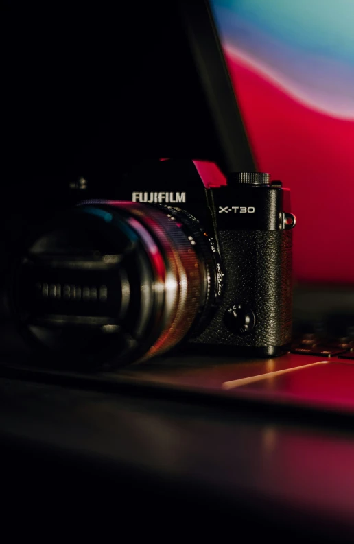 the bottom part of a black digital camera on a table