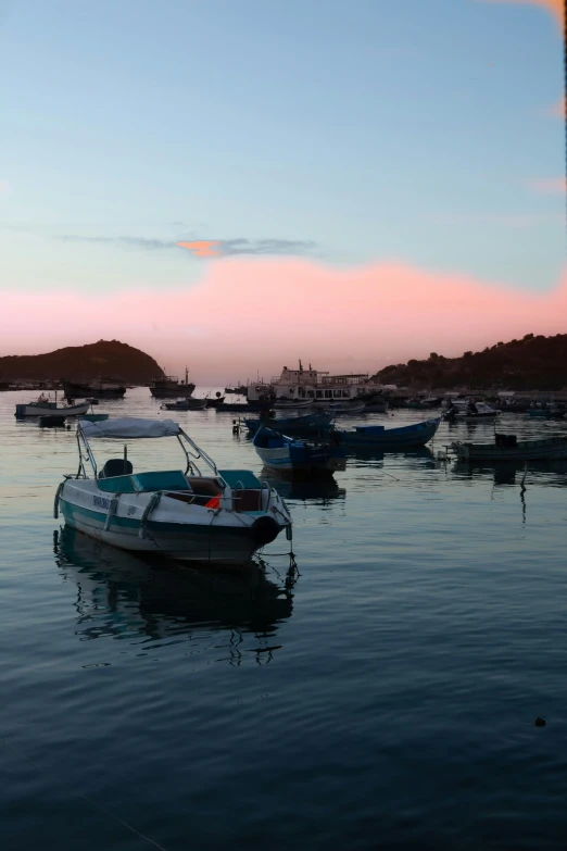 a group of small boats are floating on the water