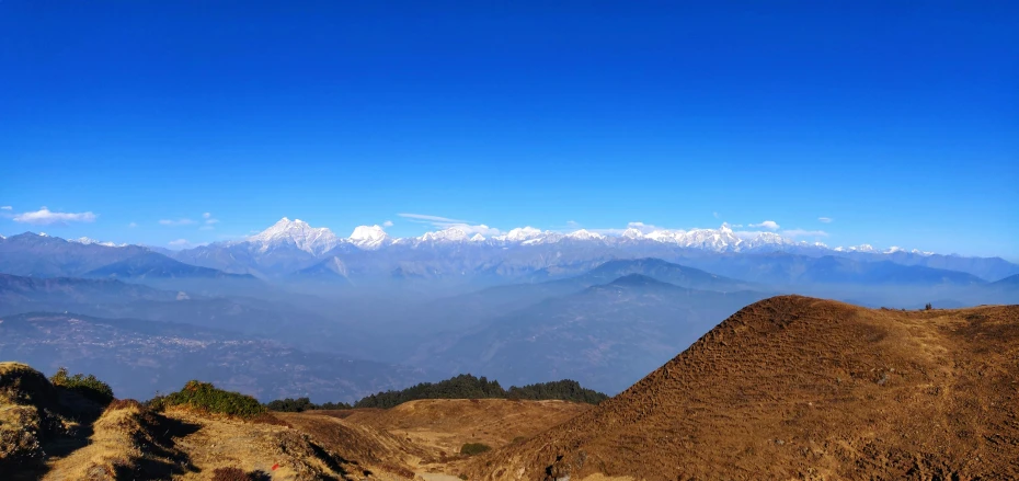 mountains covered with snow, a few clouds, and blue sky