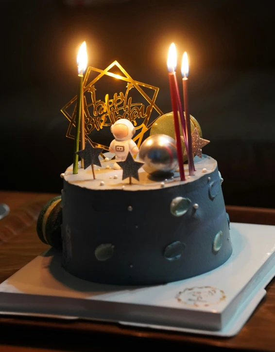 a cake with two candles lit and decorations