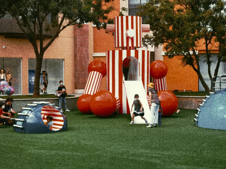 three children play on a playground that looks like a patriotic building