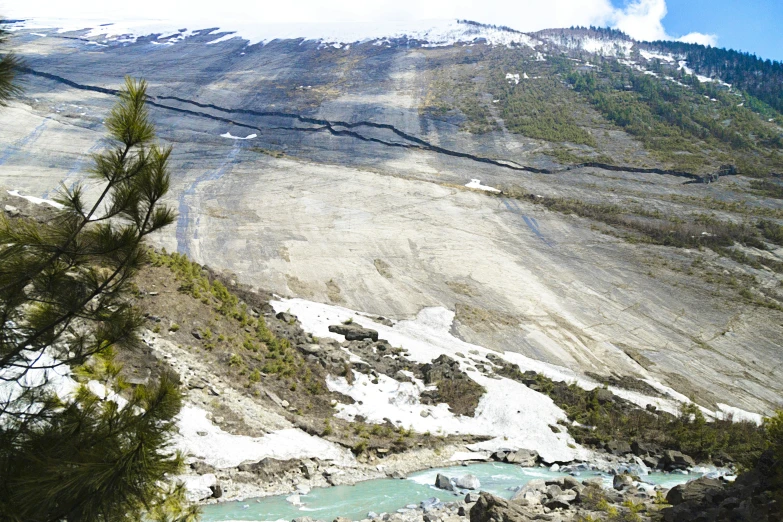 the mountain side is covered with snow and ice