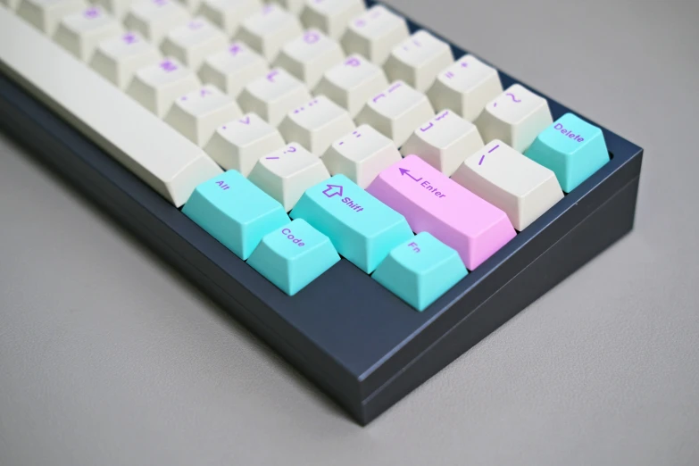 a computer keyboard has pink and blue keys