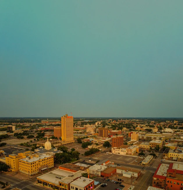 a town from a height view point showing a cloudy blue sky