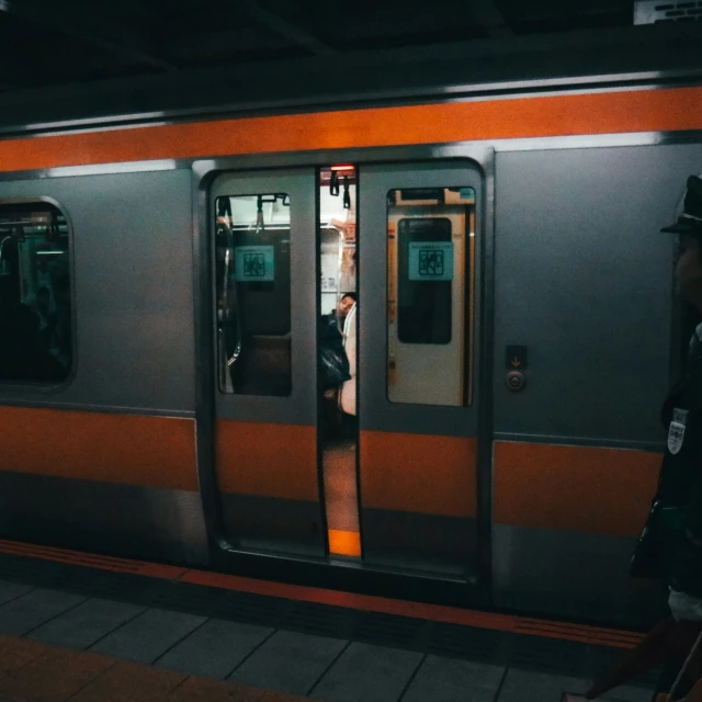 a man standing at the doorway of a subway train