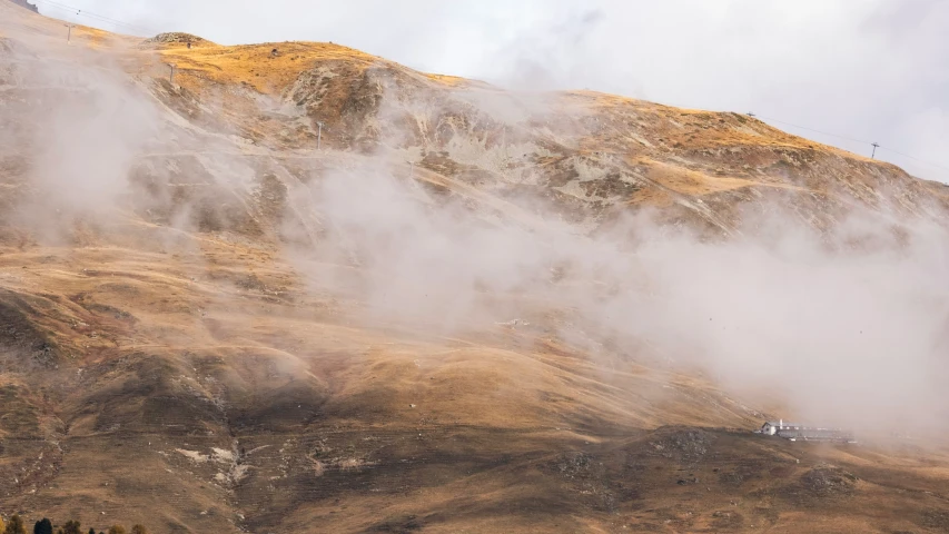 fog and steam in the air above a mountain ridge