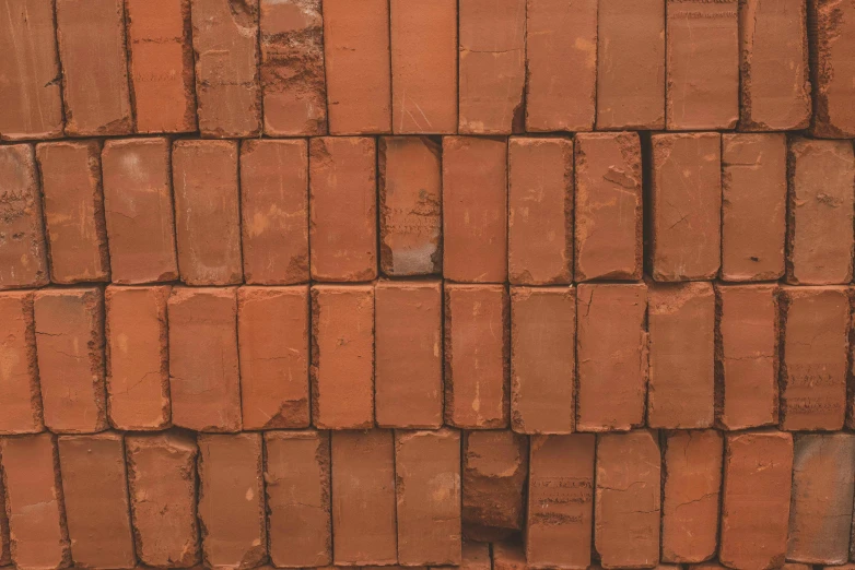 a close up of red bricks and a red bench