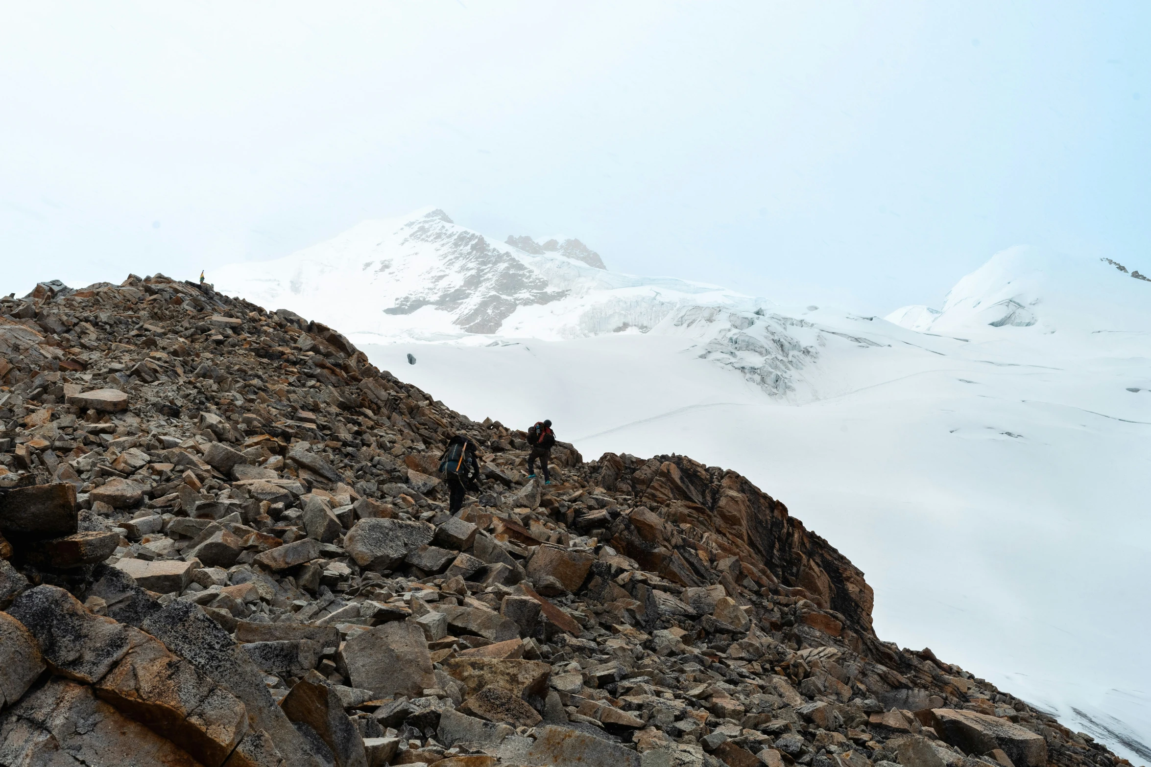 two climbers on the top of a rocky hill