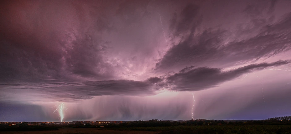 purple lightning and some pink sky at night