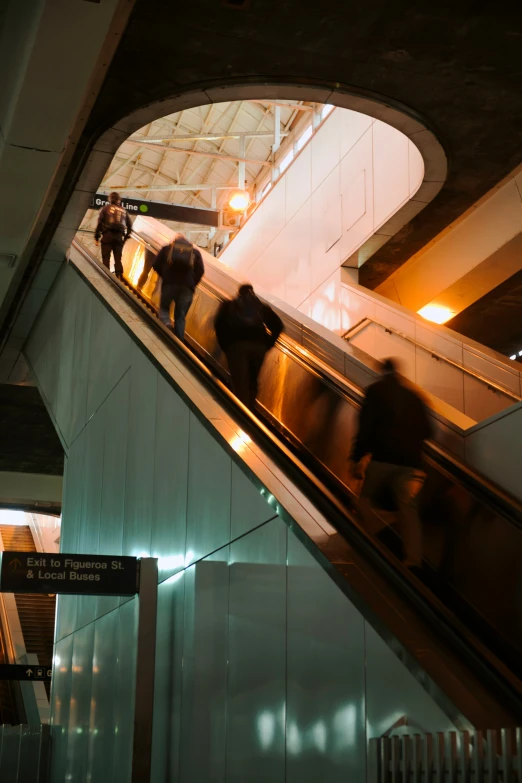 people walking on escalator in public area at night