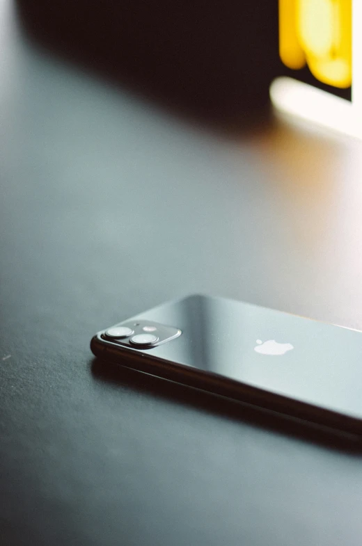 an apple cell phone sitting on a table