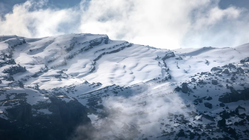 a mountain that has some snow on it