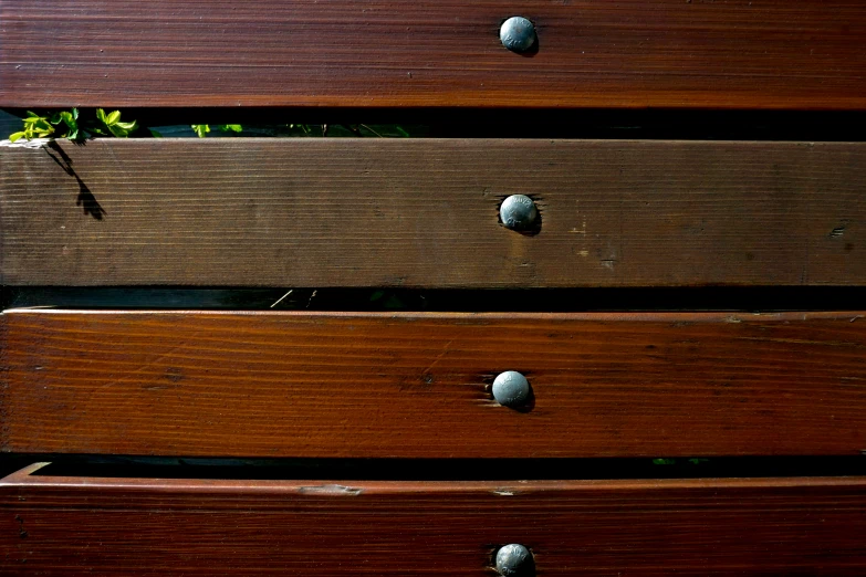 two brown wooden drawers with one closed and one opened