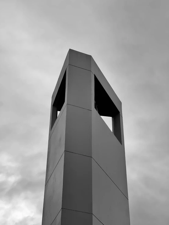 a gray building is on a cloudy day