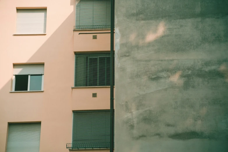 some windows and shutters in front of a building