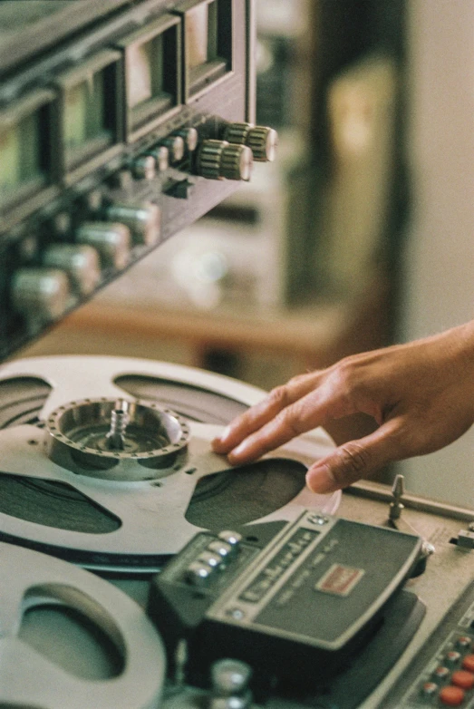 a person reaching for some type of record player