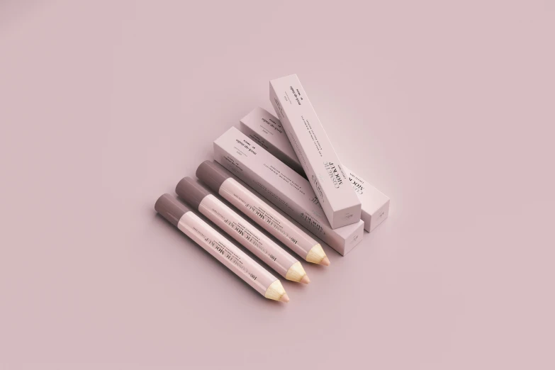 several white pencils are sitting next to each other on a pink surface