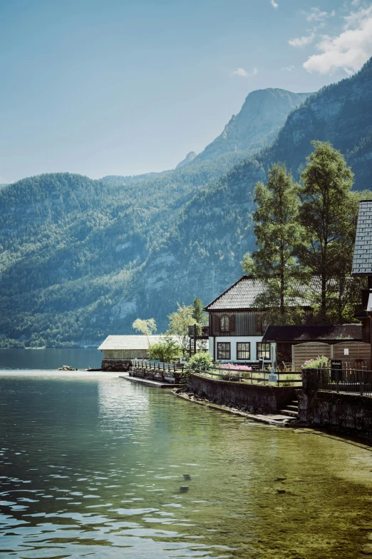 two cottages line the shore of a large body of water