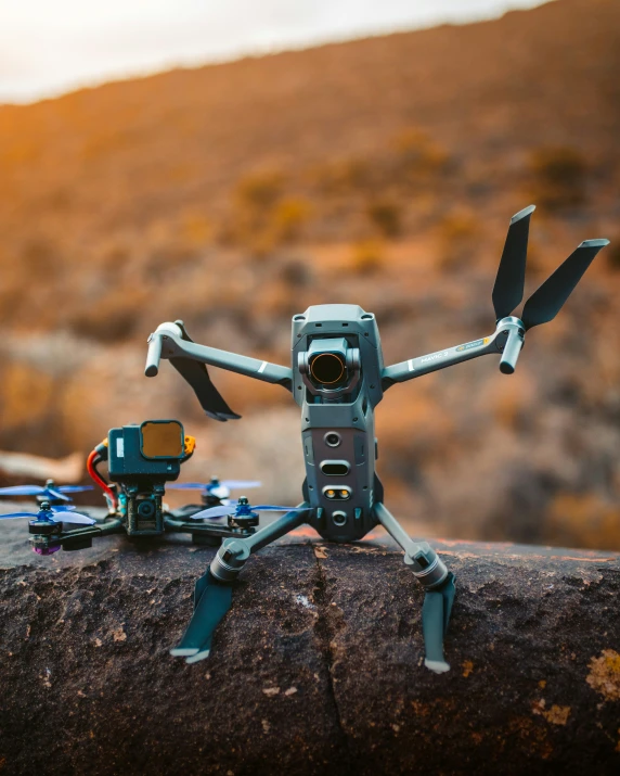 a remote controlled helicopter sitting on top of a log