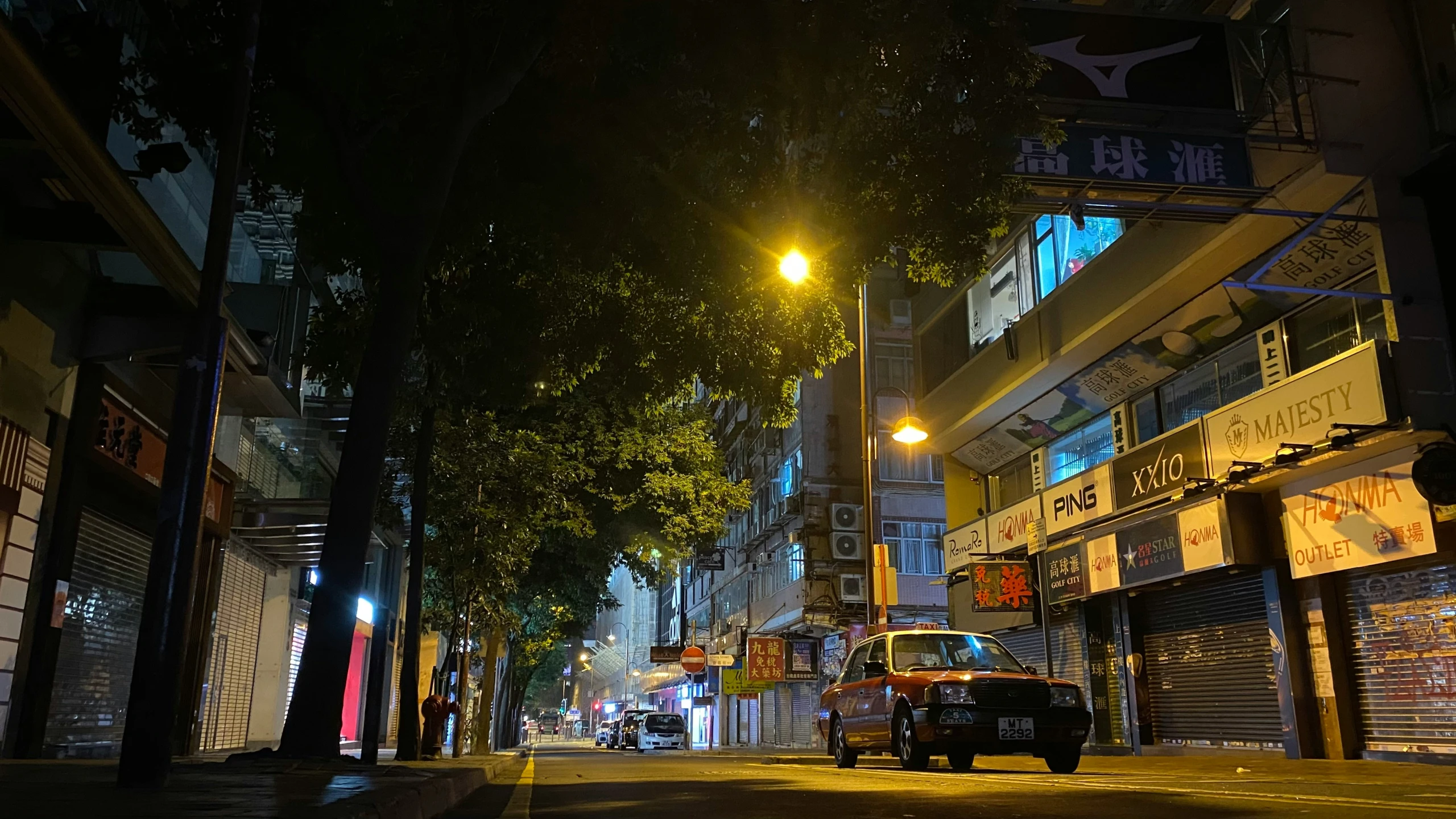 a city street at night with lots of lights on