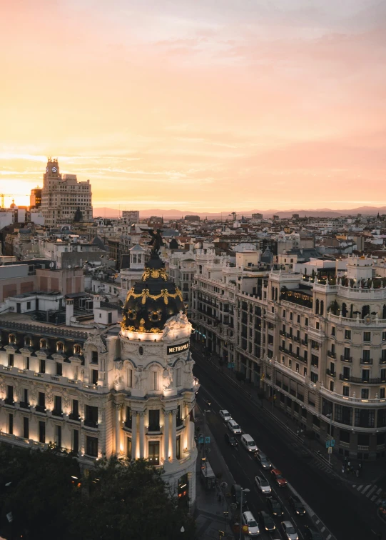 the view from atop the tower shows a beautiful city at sunset