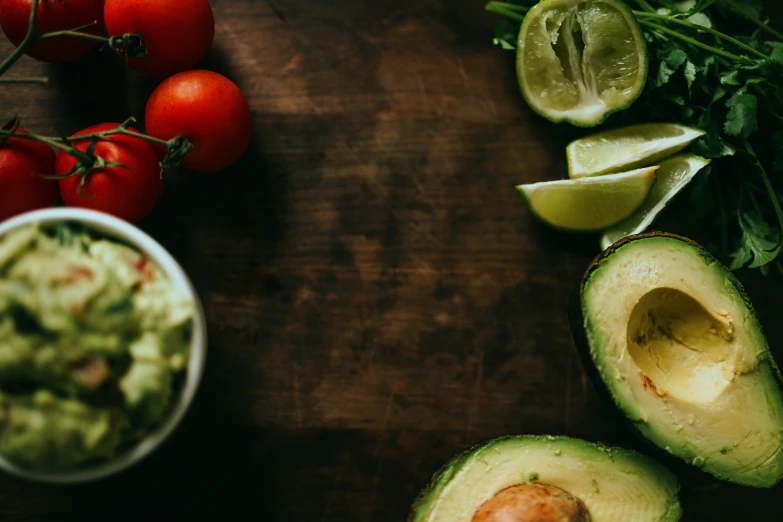 an avocado and ingredients are laid out on a table