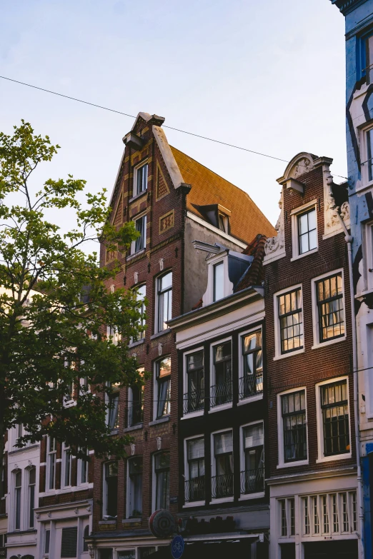 the two story brick buildings are surrounded by trees