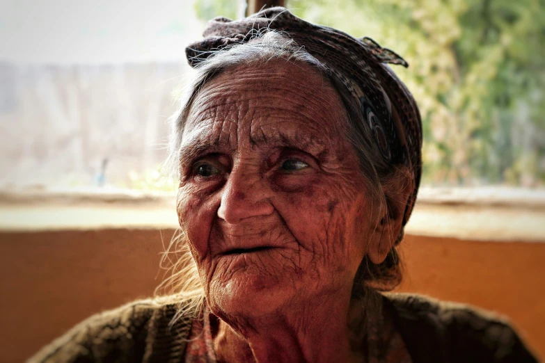 the old woman has wrinkles all over her face